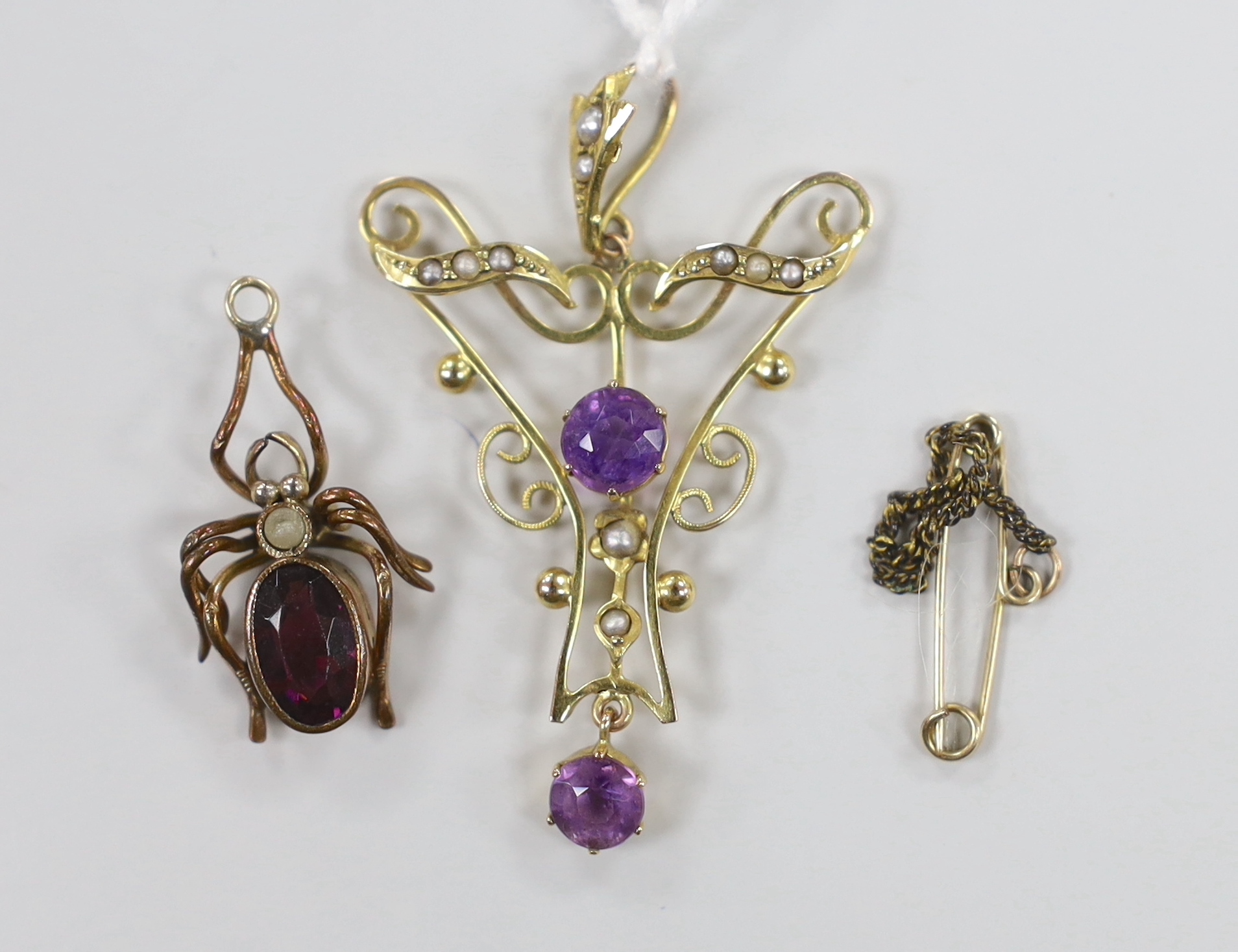 An Edwardian 9ct amethyst and seed pearl set drop pendant, 4cm, gross weight 1.7 grams and a gilt metal and paste set bug pendant.